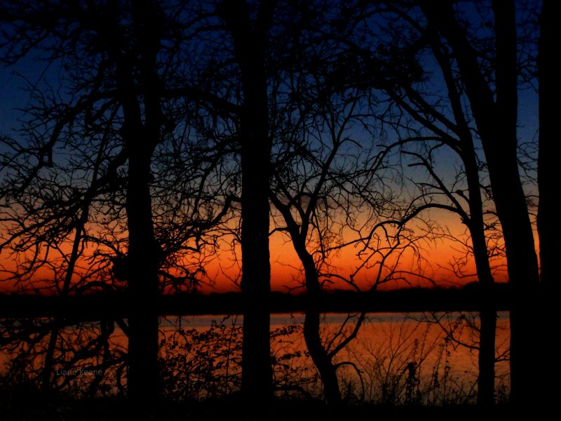 Gorgeous photograph of the sun setting over a lake in Minnesota.