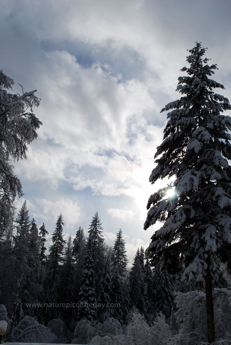 Sun peaking through clouds.  Snow gloves, thermal underwear.  