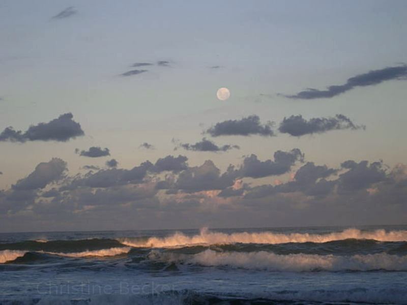 Moonrise and sunset over the beach in Australia.