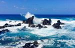 Blue water, and waves crashing over rocks in Maui, Hawaii