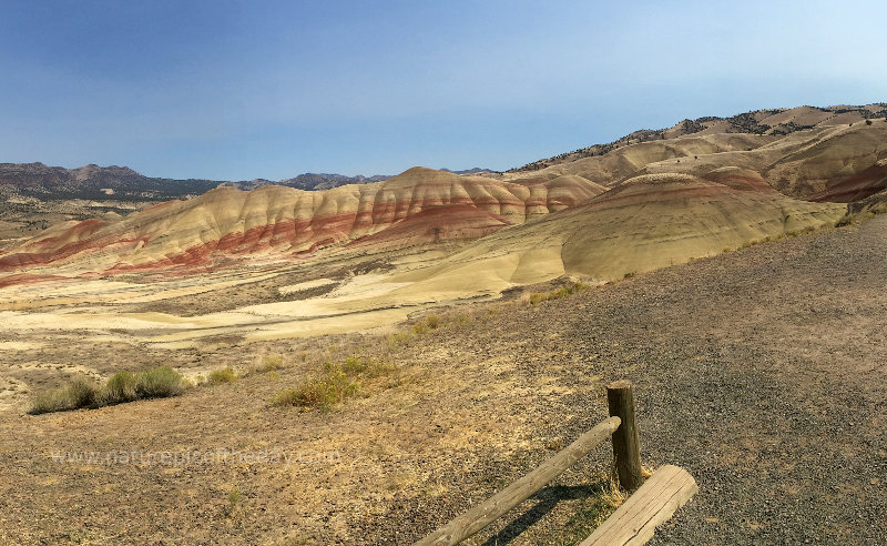 A hill with layers of different colored sediment.